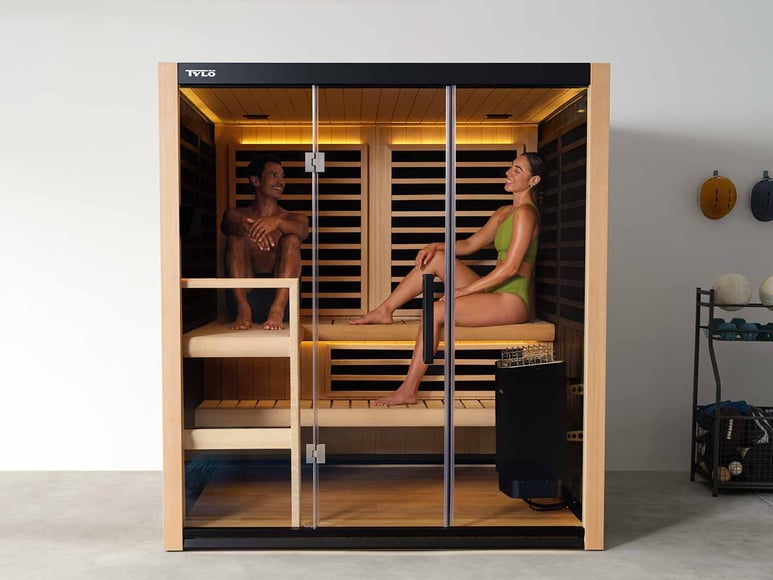 Two people sitting in a Kiruna Hybrid 3 sauna