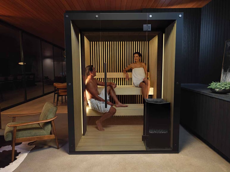 Two people sitting in a Reflection sauna
