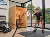 A person using exercise ropes in front of a Halmstad sauna